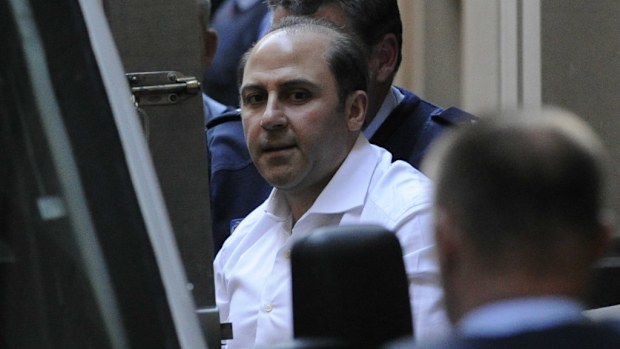 Tony Mokbel is lead away from the Supreme Court by prison guards in 2012. (AAP Image/Julian Smith)