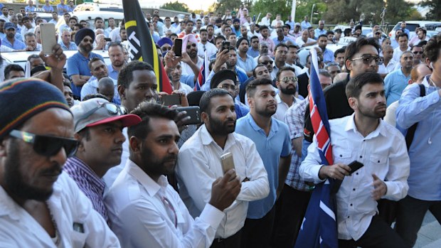 Taxi drivers listen to transport minister Dean Nalder address their concerns about ride-sharing company Uber outside WA parliament. (AAP)