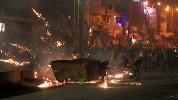 At least 10,000 Palestinian protesters clash with Israeli soldiers between Jerusalem and Ramallah. (Abbas Momani/AFP/Getty Images)