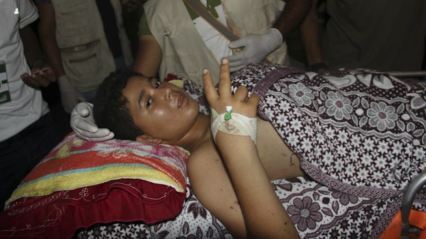 A Palestinian child who was injured in the war in Gaza as he is prepared to be moved by ambulance to Cairo after crossing the Gaza Egypt border. (AP) 