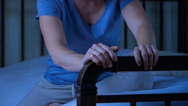 Sad wife sitting on bed