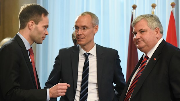 Finnish Trade Minister Kai Mykkanen (L) talks with Sweden Trade Secretary of State Oscar Stenstrom (C) and British Trade and Investment Minister Mark Price during an Trade Foreign Affairs ministers meeting at EU Headquarters in Brussels on November 11, 2016. (AFP)