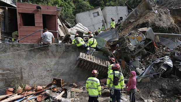 Rescue workers searching through debris. (AAP)
