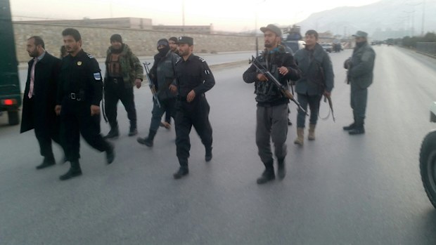 Afghan policemen stand guard at the site of a suicide bomb attack in Kabul. (Reuters)