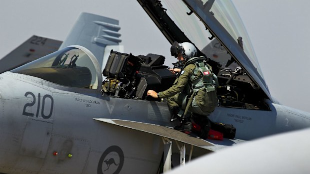 A 1 Squadron's F/A-18F crew member climbs from his aircraft after arriving at RAAF Base Darwin for Exercise Pitch Black. (AAP)