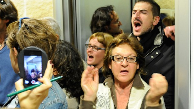 Residents of L'Aquila shout their disappointment after an appeals court cleared seven experts charged with failing to adequately warn residents of earthquake risk. (AAP)