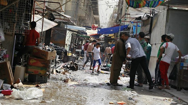 Civilians inspect the site of a bombing in Baghdad last week. (AAP)