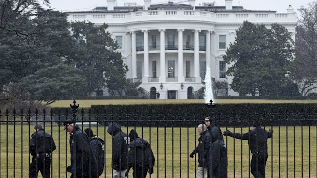 Secret Service officers and police search the south grounds of the White House. (AAP)