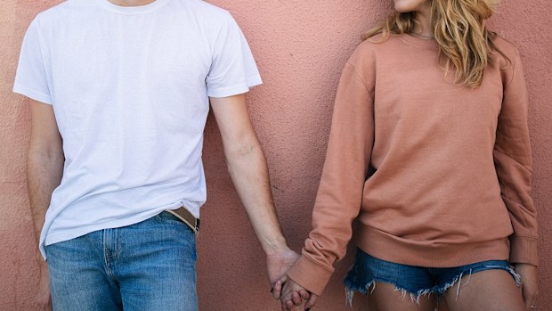 Teenagers holding hands.