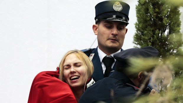 A Femen activist is arrested by Vatican gendarmes. (AAP)