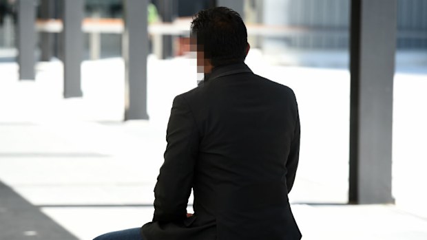 A former Brisbane Grammar student, who cannot be identified, poses for a photo outside the Magistrates Court in Brisbane. (AAP)