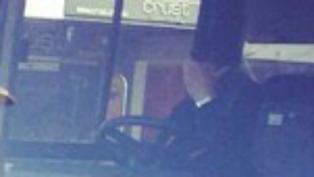 A bus driver reacts after colliding with an expensive Mercedes.