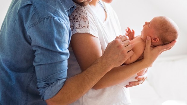 Couple holding newborn baby