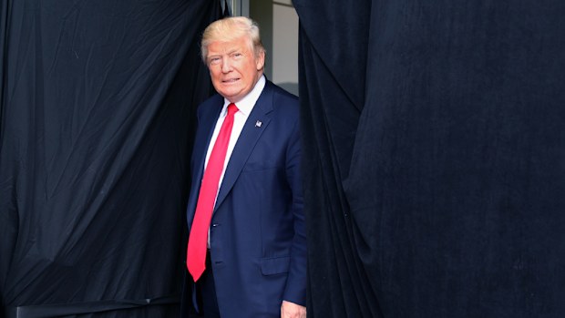 Republican presidential candidate Donald Trump comes out from behind a curtain to take the stage at an event on October 15, 2016 in Portsmouth, New Hampshire. (AFP)