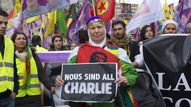 People demonstrate holding up a sign reading Je suis Charlie during a rally in Paris. (AAP)