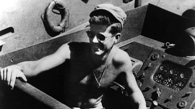 JFK at the controls of his patrol boat during WWII. (Getty Images)