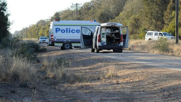 Police vans block a road leading to the scene of the fatal shooting of an environment department worker on a property north of Moree. 