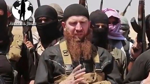 Omar al-Shishani stands next to the group's spokesman in an undated video. (AP)
