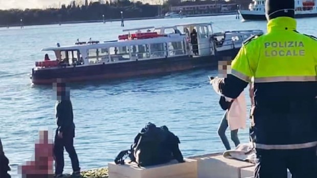 The woman took a dip in the icy water before posing topless for photos on the war memorial.