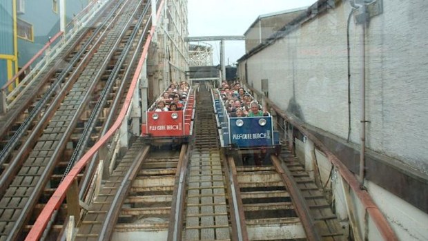 Two carriages alongside each other on the Grand National roller coaster. (Supplied)