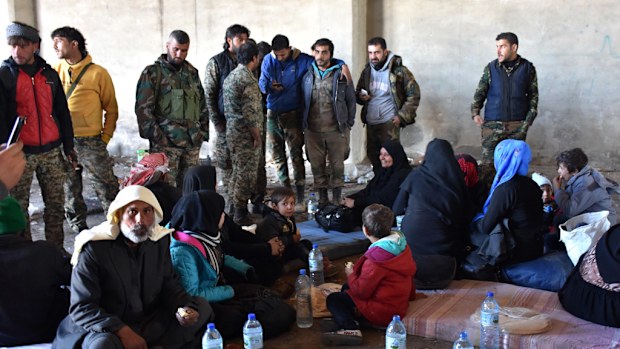 Syrian displaced families gather at a makeshit camp on November 27, 2016 in the government-held district of Jibreen in Aleppo. (AFP)