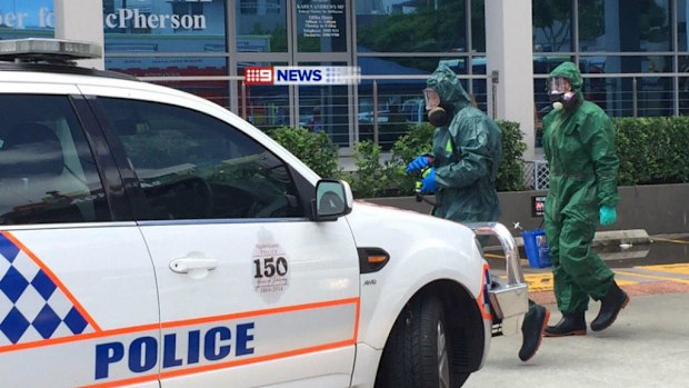 Officers in Hazmat suits attended the scene. (9NEWS)