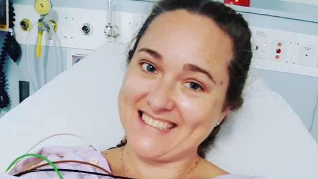 Mandy smiling in bed