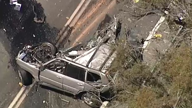 The driver of the car has reportedly been killed after colliding with a truck. (9NEWS)