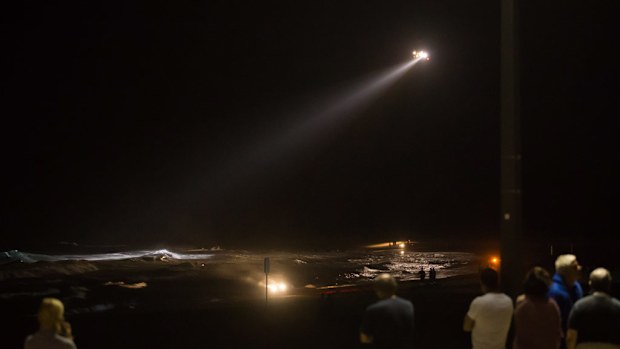 Police and emergency crews scour the water for the missing teenager. (Sage Barreda/Supplied)