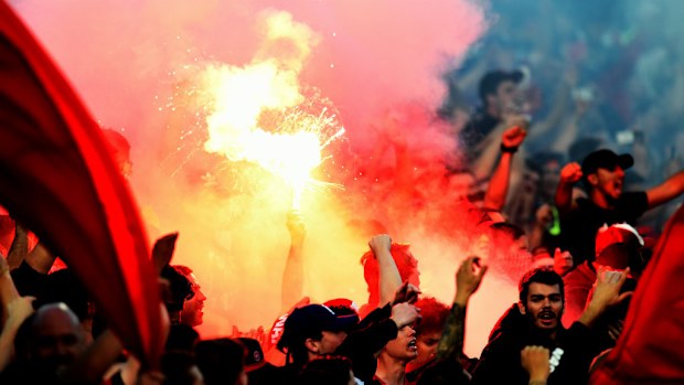 A flare in the stands at Pirtek Stadium last night. (AAP)