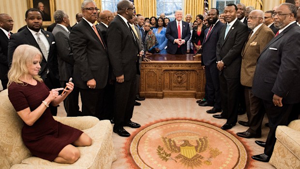 Kellyanne Conway says she 'meant no disrespect' when she knelt on the Oval Office sofa. (AFP)