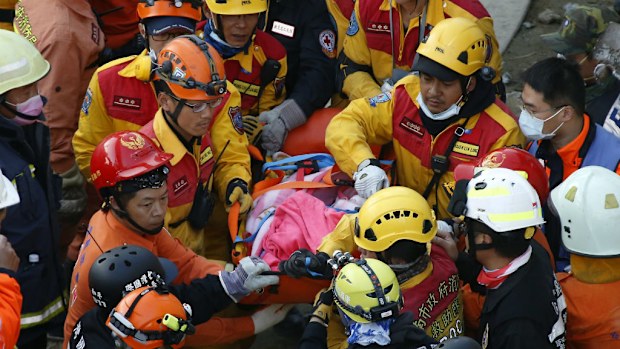 A freed woman is transported by rescue workers in Taiwan. (AAP)