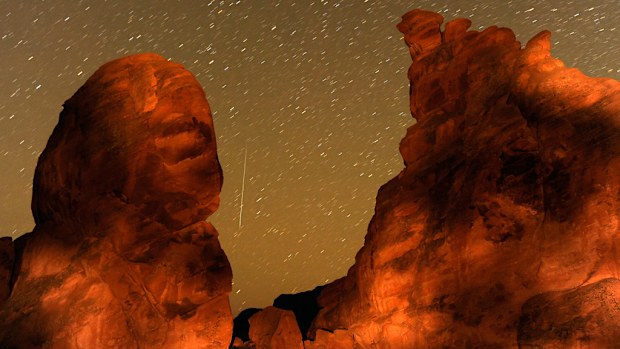 A Geminid meteor streaks between peaks of the Seven Sisters rock formation in Nevada, USA in December 2010. (Getty)