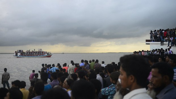 Thousands have gathered to grieve and watch the rescue efforts in Bangladesh. (Getty)