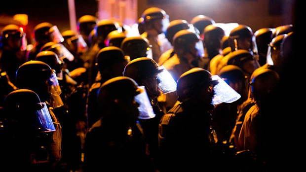 Police engage a mob after rocks and bottles were thrown by rioters (Getty)