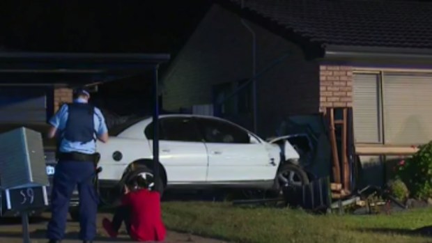 A man has fled the scene after crashing his car into a home in Sydney's Macquarie Fields. (9NEWS)