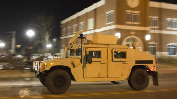 A National Guard Humvee roars through the centre of Ferguson. (Getty Images)
