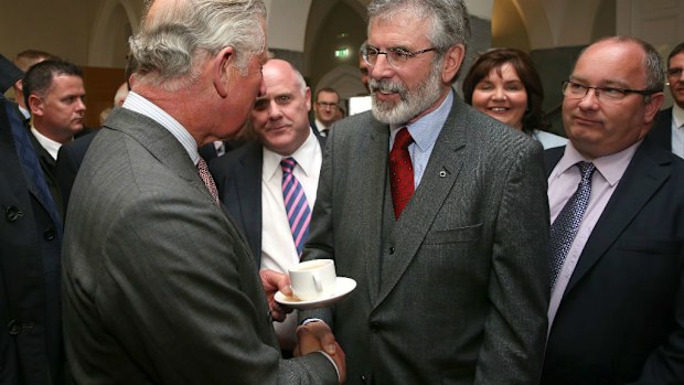 An historic moment as Britain's heir to the throne Prince Charles (L) shakes hands with Sinn Fein President Gerry Adams during his visit to the National University of Ireland in Galway. (AAP)