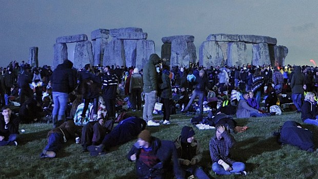 Revellers await the dawning of the summer solstice at the historic world heritage site of Stonehenge. (AAP)