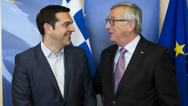 Greek Prime Minister Alexis Tsipras, left, is greeted by European Commission President Jean-Claude Juncker. (AAP)