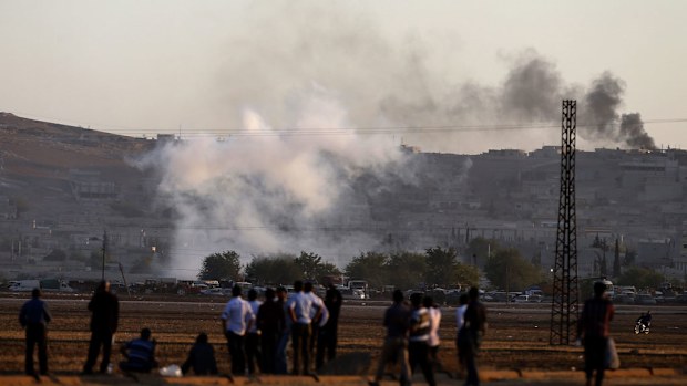 A picture taken from Turkey shows smoke rising after an apparent airstrike by allied forces against Islamic State targets in the east of the Syrian city of Kobane. (AAP)
