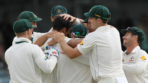 Australian bowler Mitchell Johnson (centre) is surrounded by team mates after taking the wicket of Martin Guptill on day 5 of the second Trans-Tasman Test match between Australia and New Zealand at the WACA, Perth. (AAP)