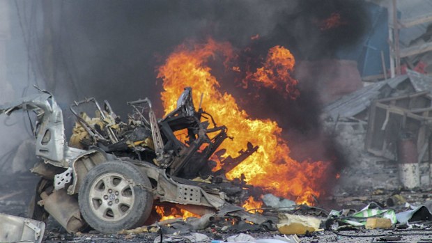 A vehicle burns after a car bomb exploded in front of the Sahafi Hotel in Mogadishu. (AAP)