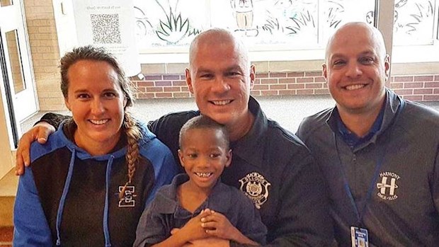Officer Tommy Norman (middle) and Tim Tim. (Facebook)