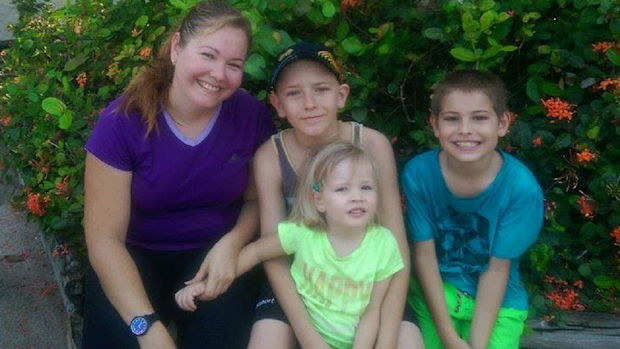 Leah with her children sitting down
