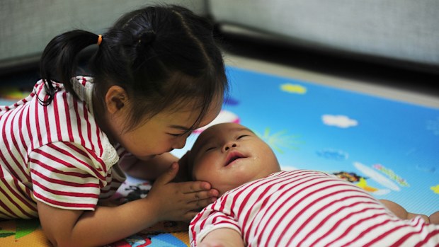A Chinese girl and her baby sibling. (AAP file image)
