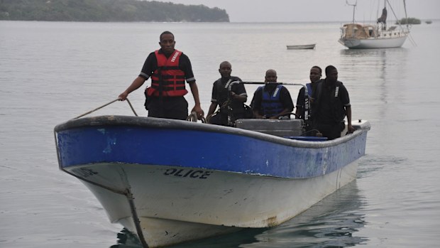 Jamaican Marine Police return to the Port Antonio Marina after a fruitless search for a plane that crashed into the ocean near Port Antonio, Jamaica. (AAP)
