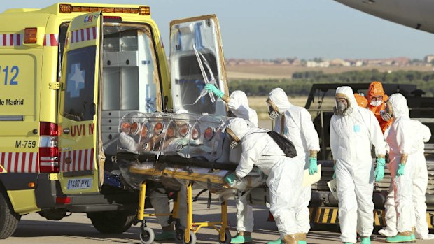 Aid workers and doctors transfer Miguel Pajares, a Spanish priest who was infected with the Ebola virus while working in Liberia. (AP Photo/Spanish Defense Ministry)