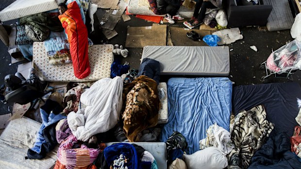 Migrants in a makeshift camp under the elevated metro station of Stalingrad, Paris. (AAP)