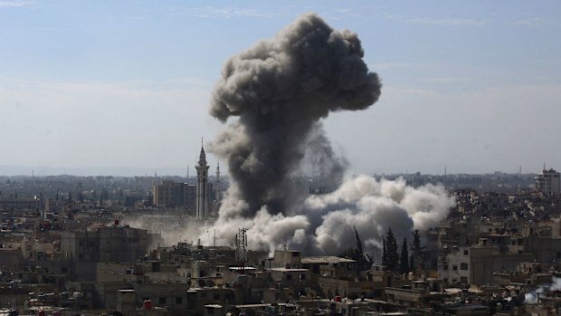 A cloud of smoke rises following an air strike by Syrian government forces in the rebel-held area of Douma, north east of the capital Damascus. (Getty)